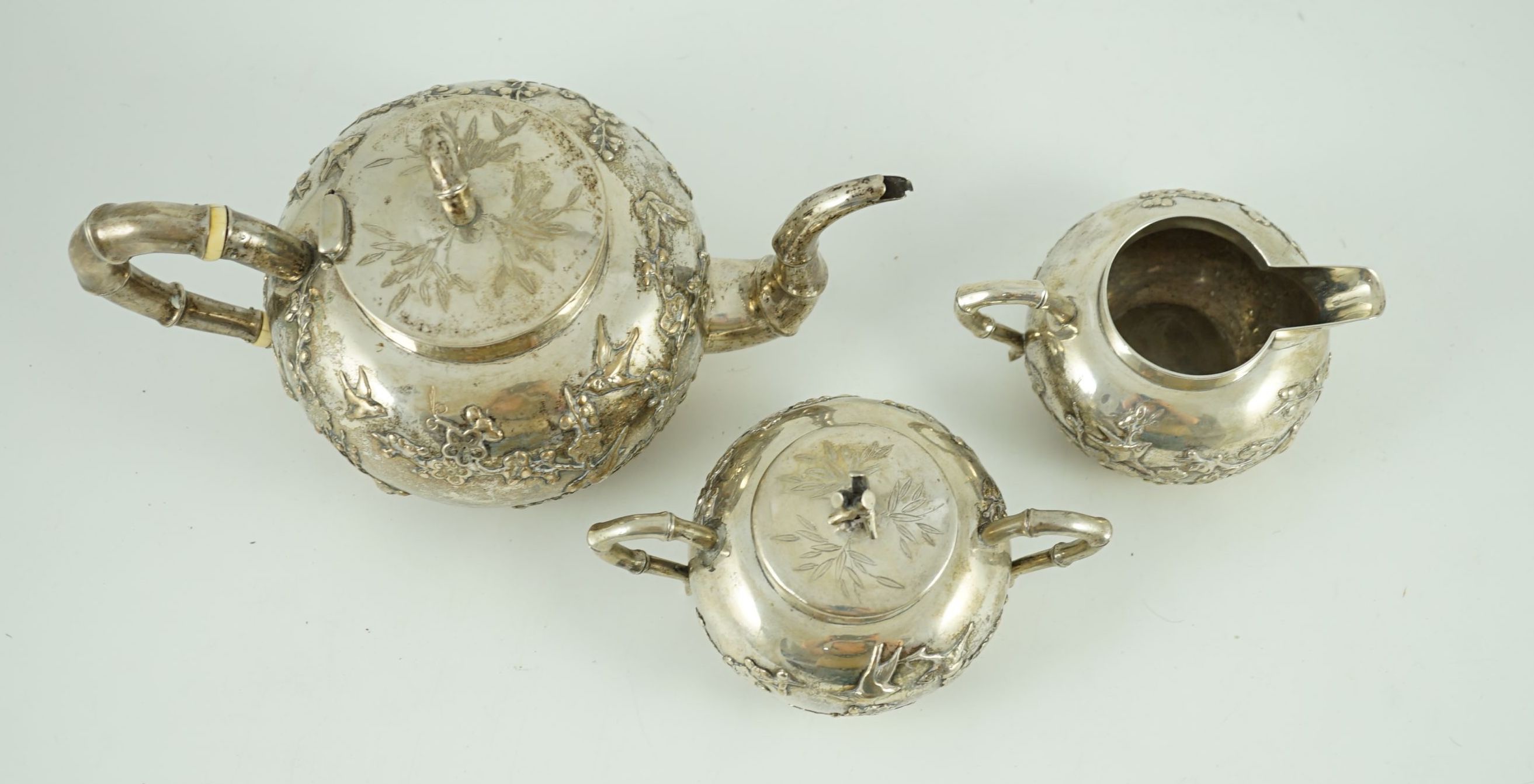 A 19th century Chinese Export silver three piece tea set by Cumshing?